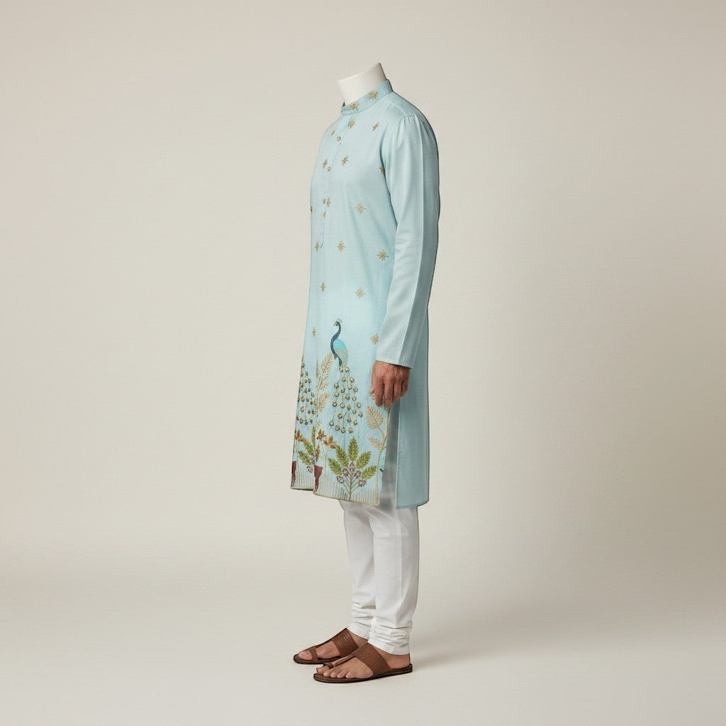 Kurti Connection USA light blue silk kurta set with intricate peacock embroidery and white pajama.
